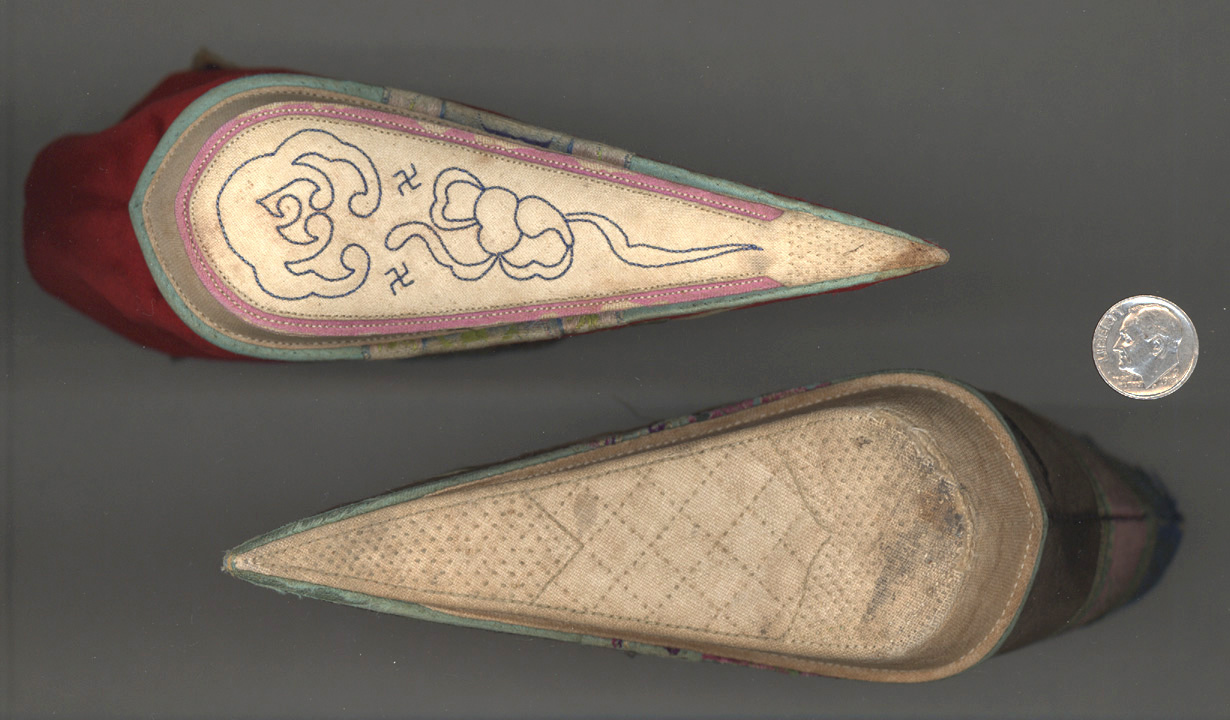 Decorated Bottom view of Red lotus shoes with dime for size reference